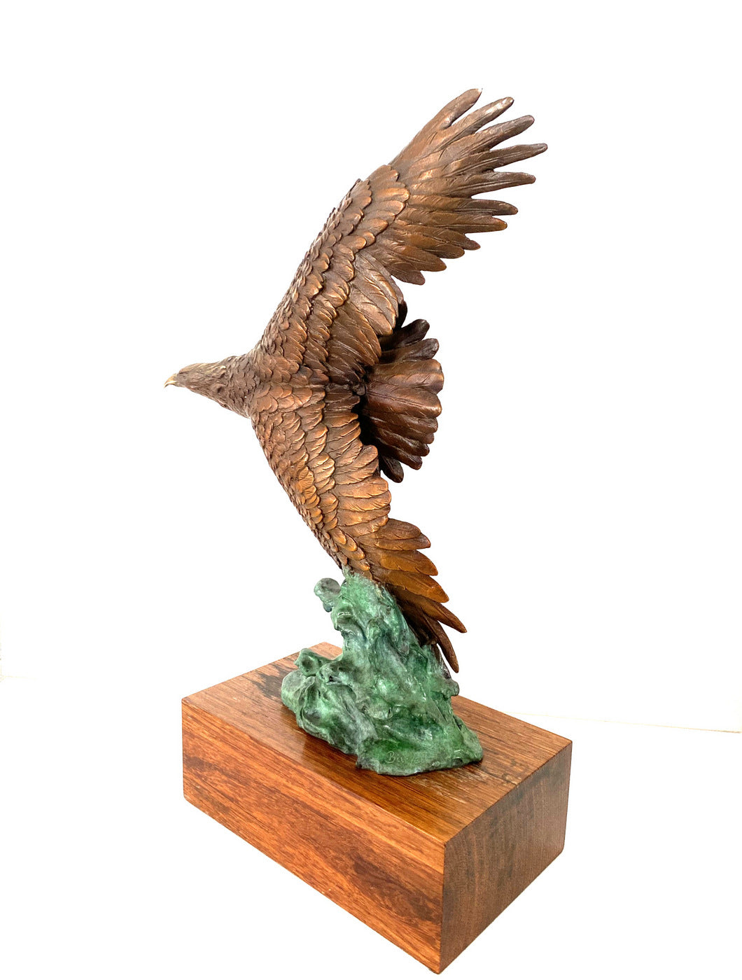 Bronze eagle on wooden base with artist signature