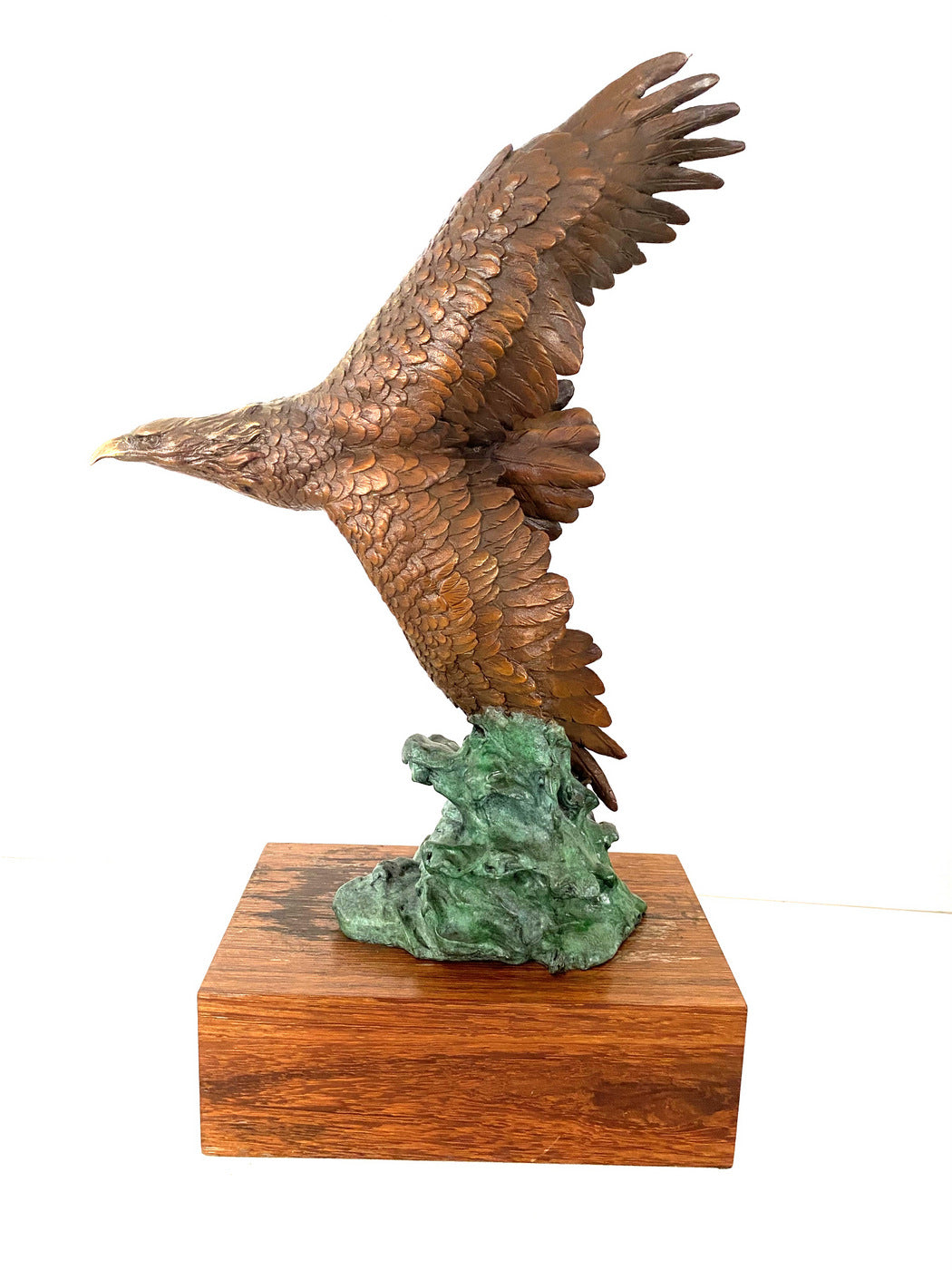 Bronze eagle on wooden base with artist signature