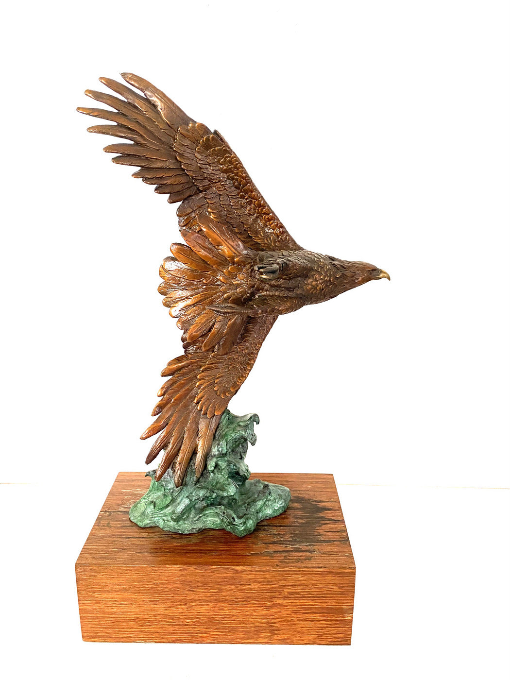 Bronze eagle on wooden base with artist signature