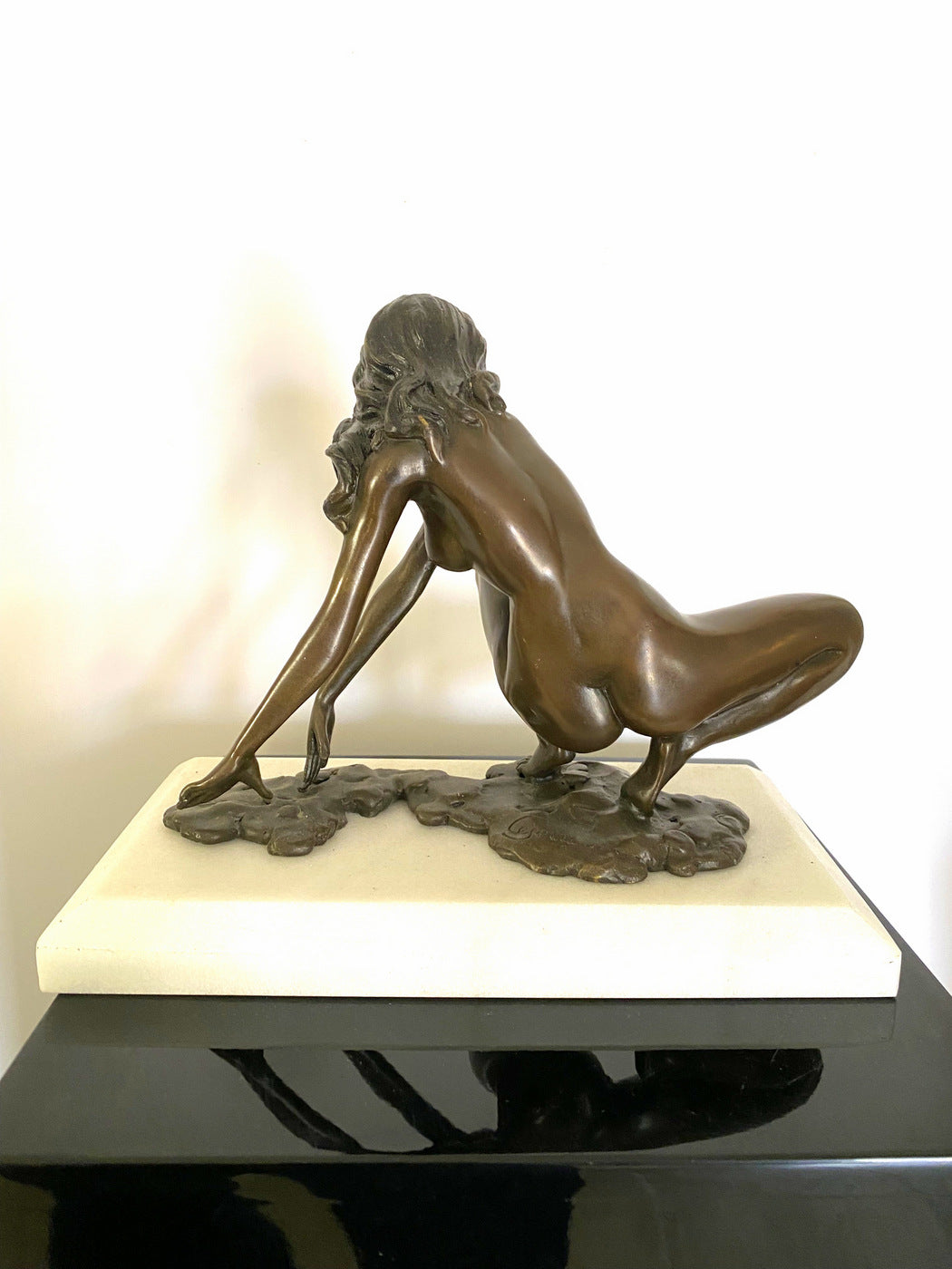 Bronze nude with artist signature on white marble base