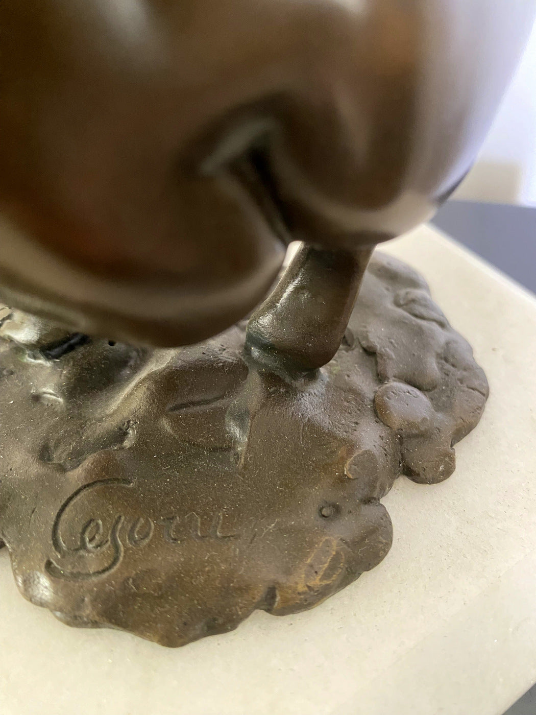 Bronze nude with artist signature on white marble base