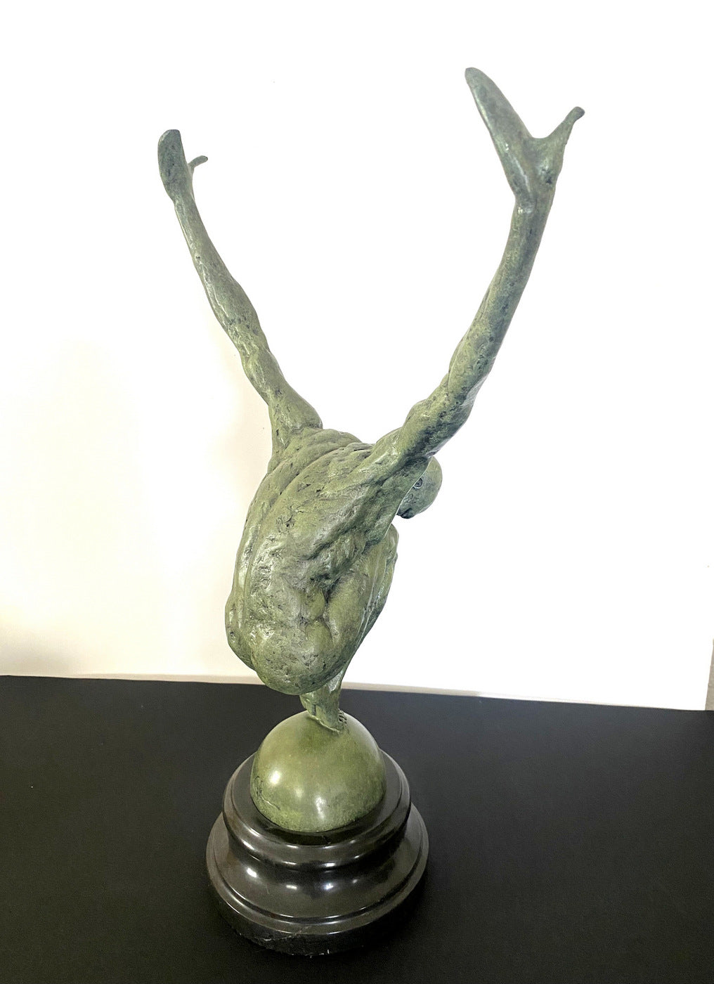 Athlete on ball signed Milo on marble base in bronze