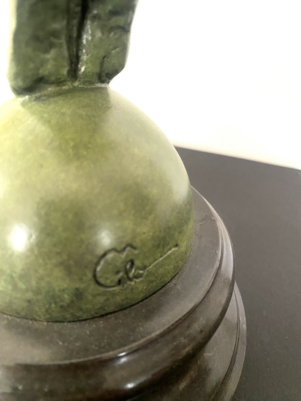 Athlete on ball signed Milo on marble base in bronze