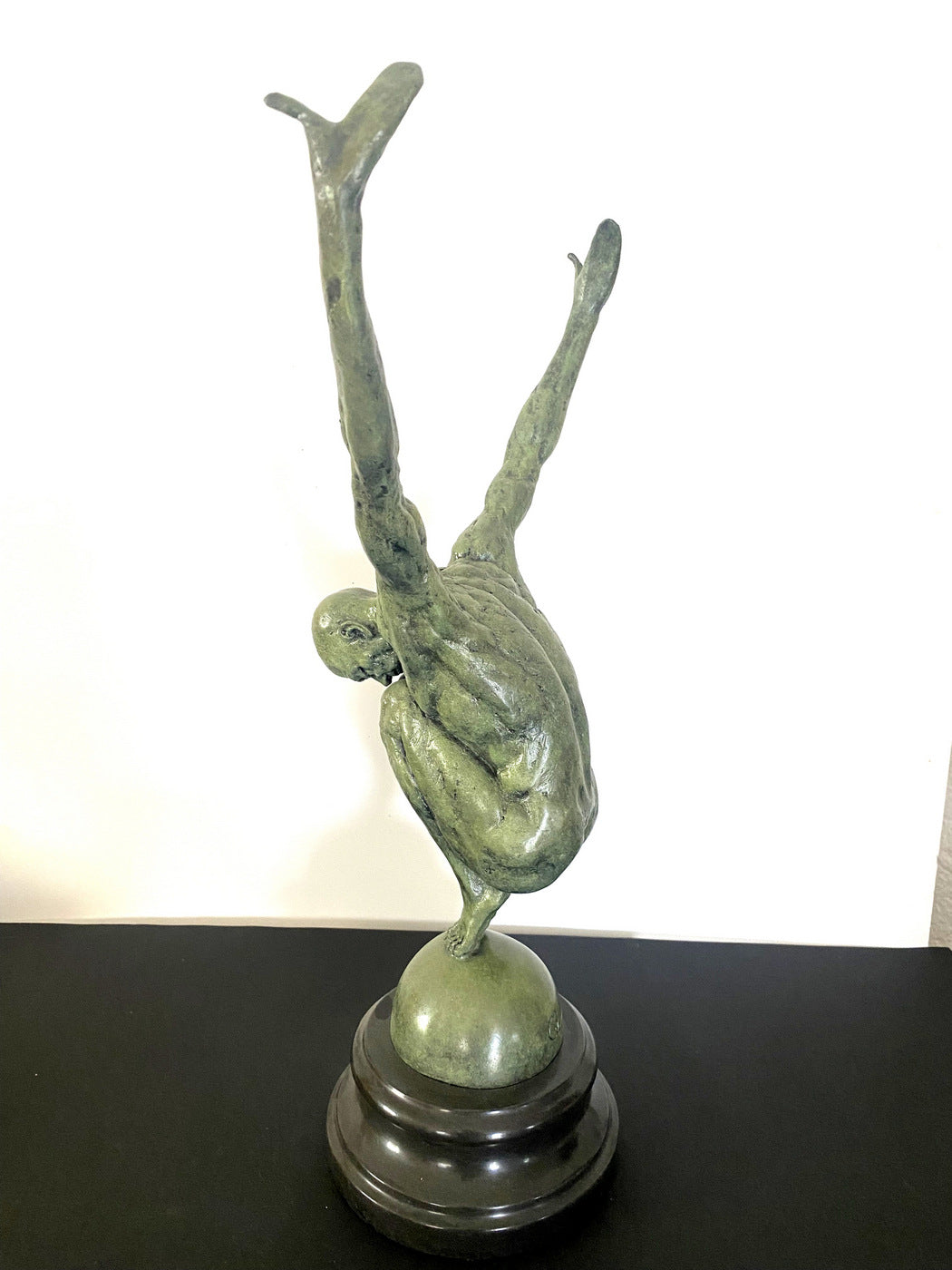 Athlete on ball signed Milo on marble base in bronze