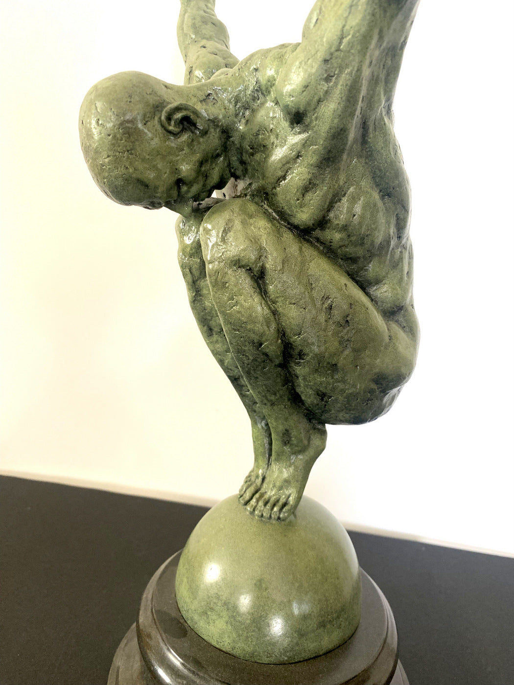 Athlete on ball signed Milo on marble base in bronze