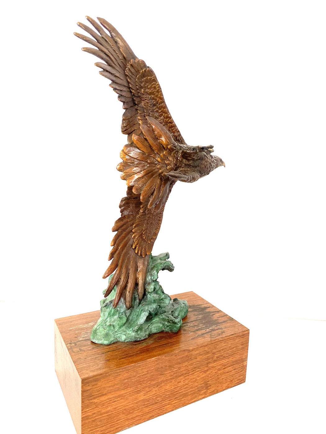 Bronze eagle on wooden base with artist signature