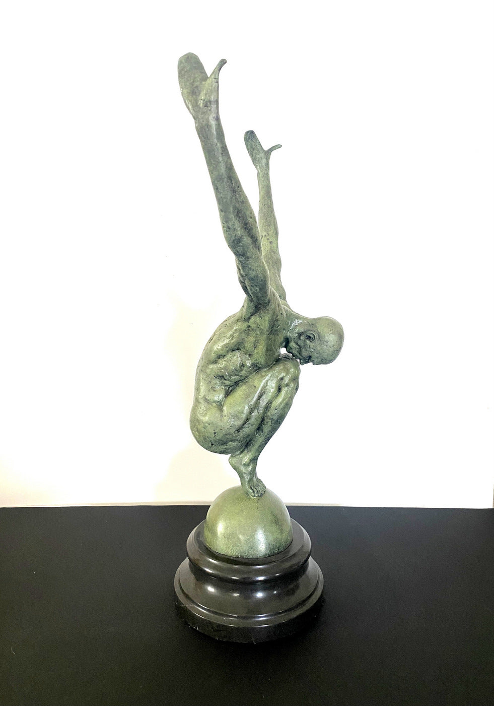 Athlete on ball signed Milo on marble base in bronze