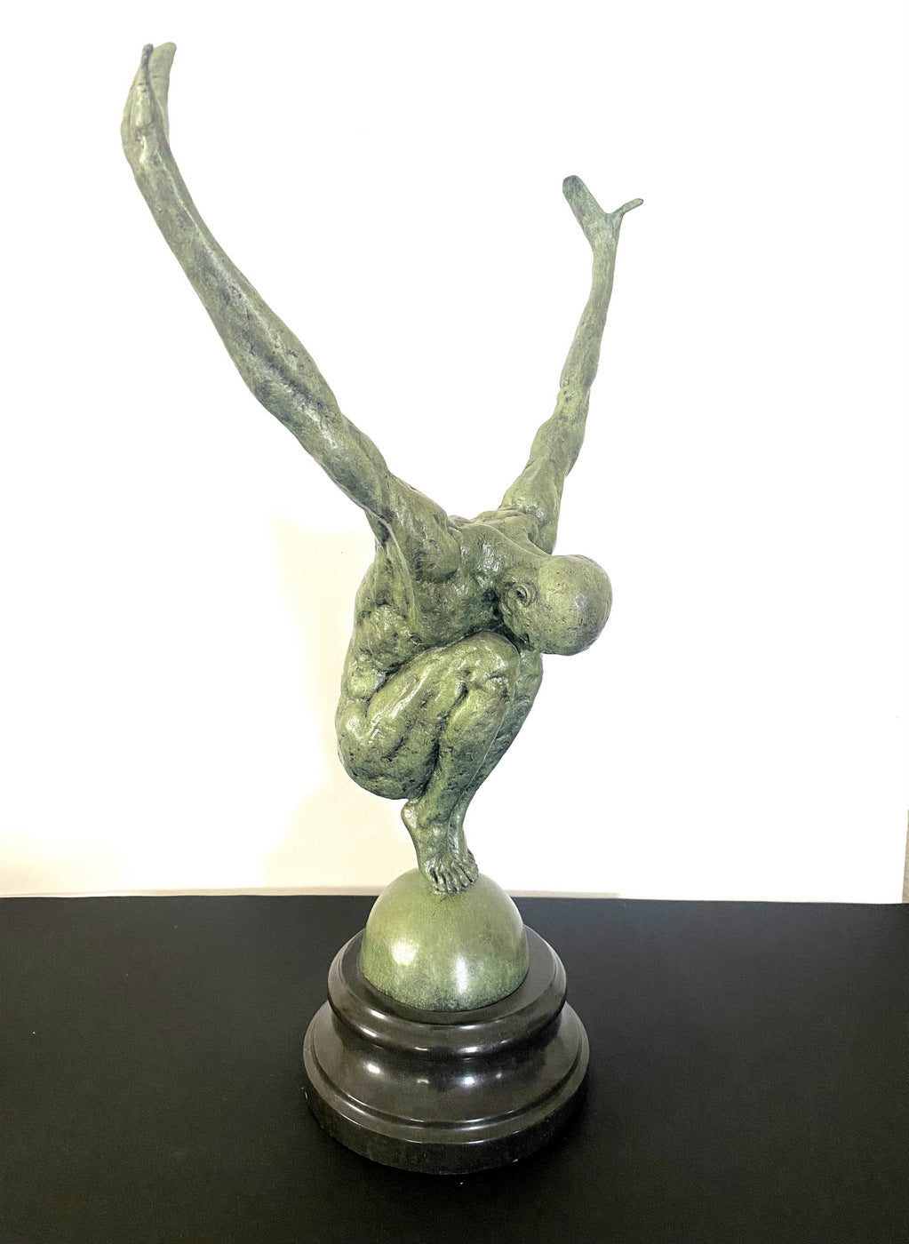 Athlete on ball signed Milo on marble base in bronze