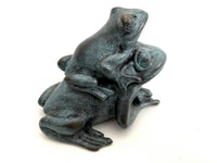 Grün patinierte Froschgruppe aus Bronze schräg von hinten mit sichtbaren Hinterbeinen