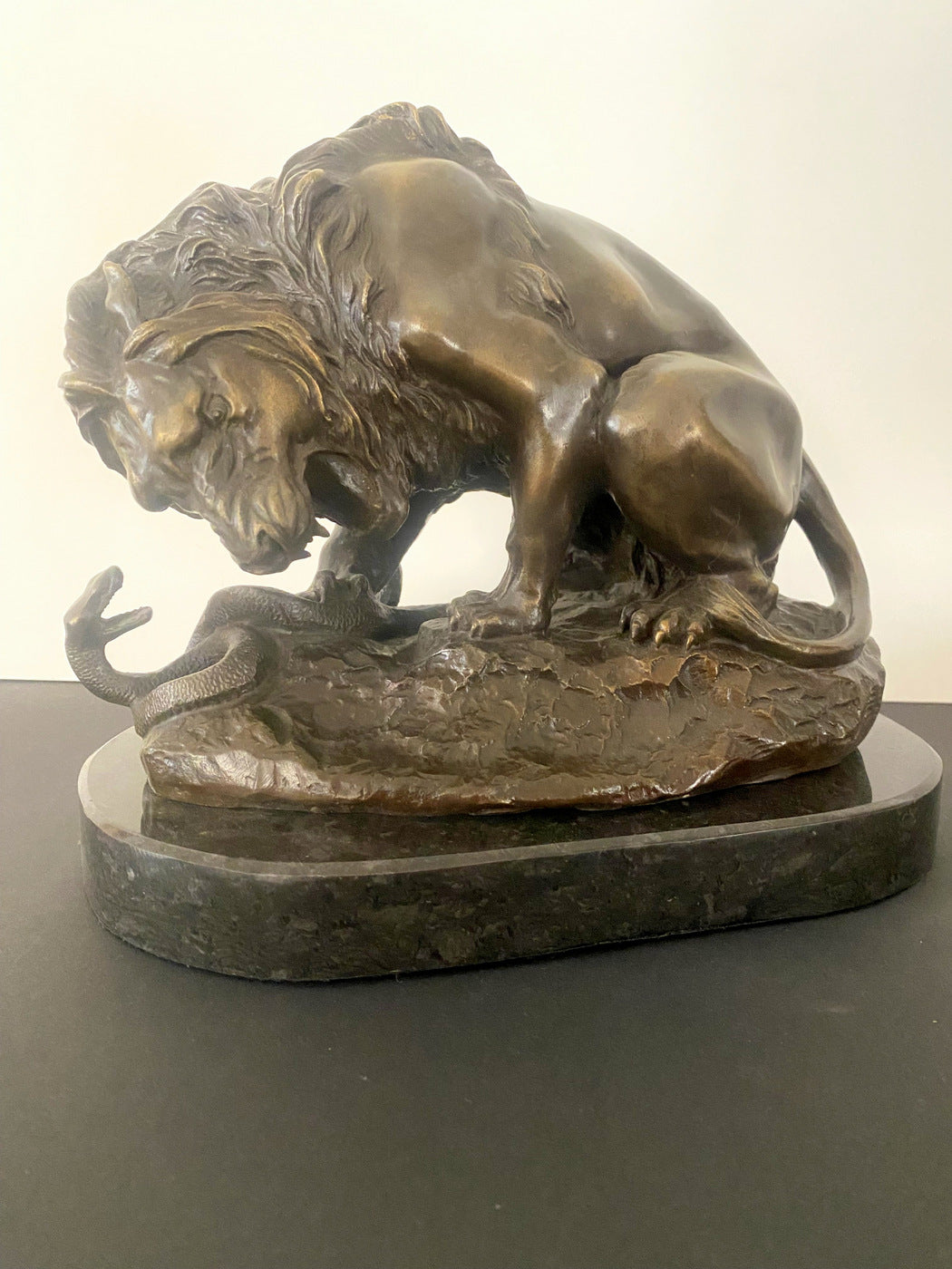 Animal figure bronze lion with snake signed Barye on marble base